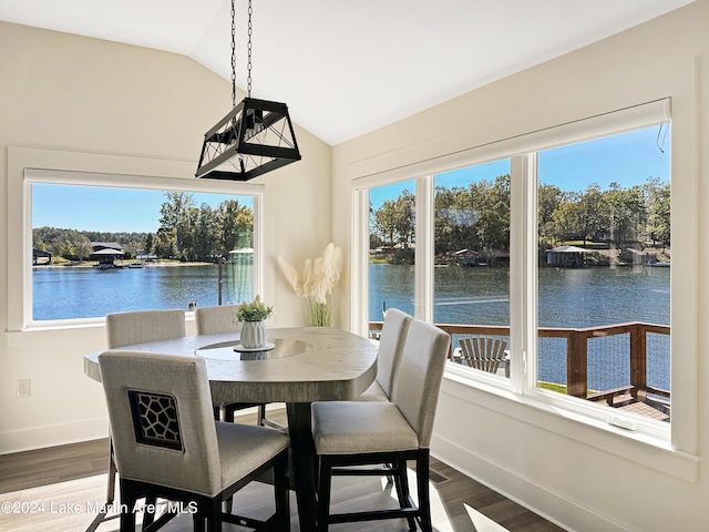 dining area featuring a healthy amount of sunlight and a water view