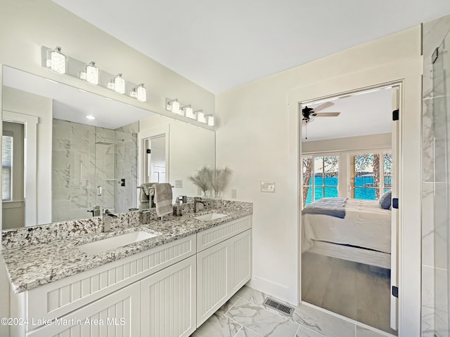 bathroom featuring walk in shower, vanity, and ceiling fan