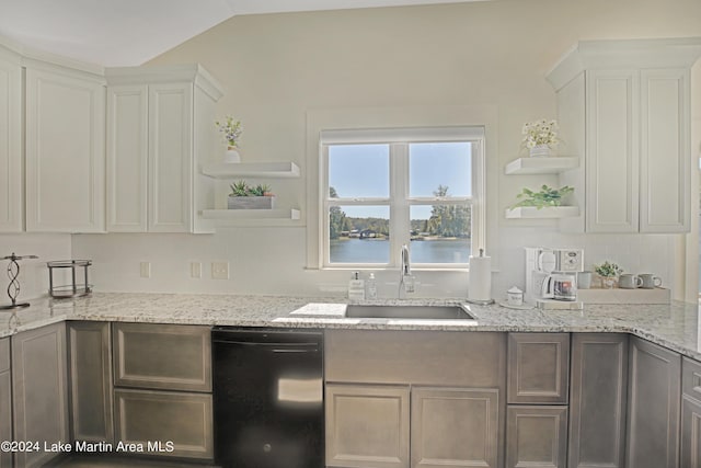 kitchen with white cabinetry, a water view, light stone counters, and black dishwasher