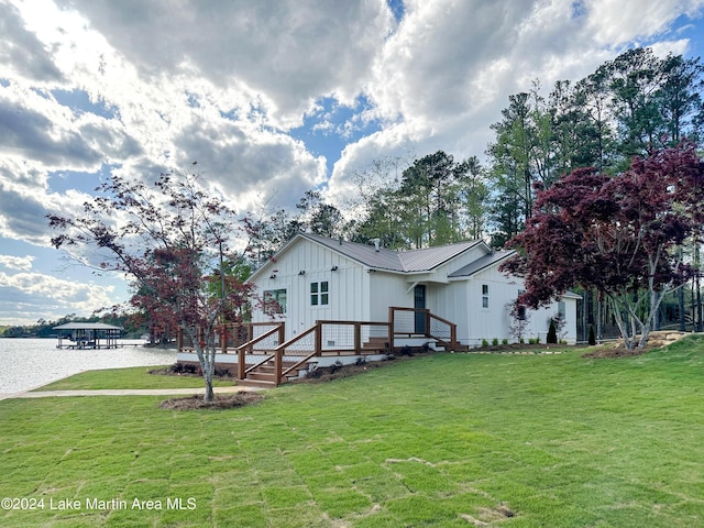 exterior space featuring a water view and a front lawn