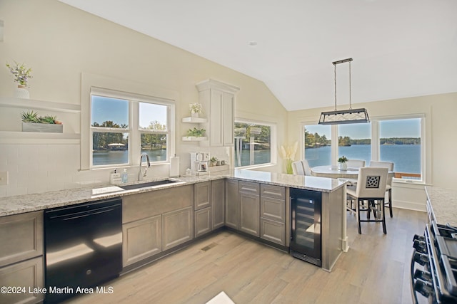 kitchen featuring dishwasher, lofted ceiling, wine cooler, and a healthy amount of sunlight