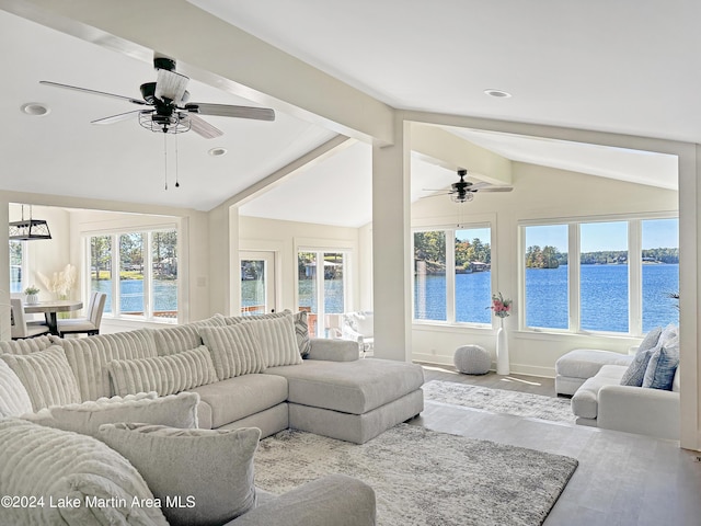 living room featuring vaulted ceiling with beams, ceiling fan, light hardwood / wood-style flooring, and a water view