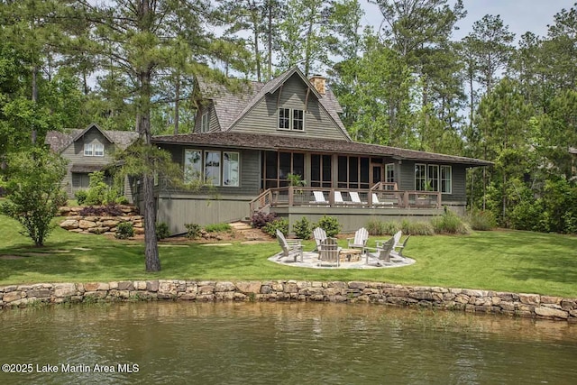 326 Bulgers Mill Loop, Alexander City, AL 35010 - rear view of house featuring an outdoor fire pit, a lawn, a sunroom, and a deck with water view