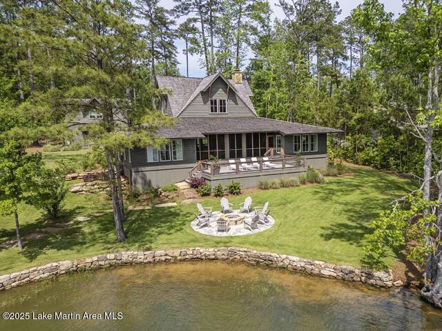 326 Bulgers Mill Loop, Alexander City, AL 35010 - back of property featuring a fire pit, a sunroom, a lawn, a chimney, and a deck with water view