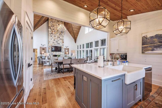326 Bulgers Mill Loop, Alexander City, AL 35010 - kitchen with appliances with stainless steel finishes, wooden ceiling, a chandelier, light wood-style flooring, and a sink