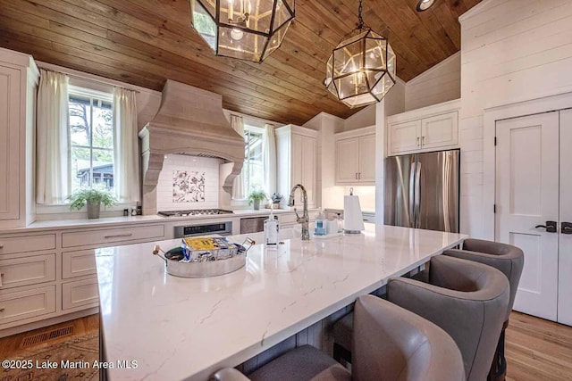 326 Bulgers Mill Loop, Alexander City, AL 35010 - kitchen featuring wooden ceiling, stainless steel appliances, healthy amount of natural light, premium range hood, and a chandelier