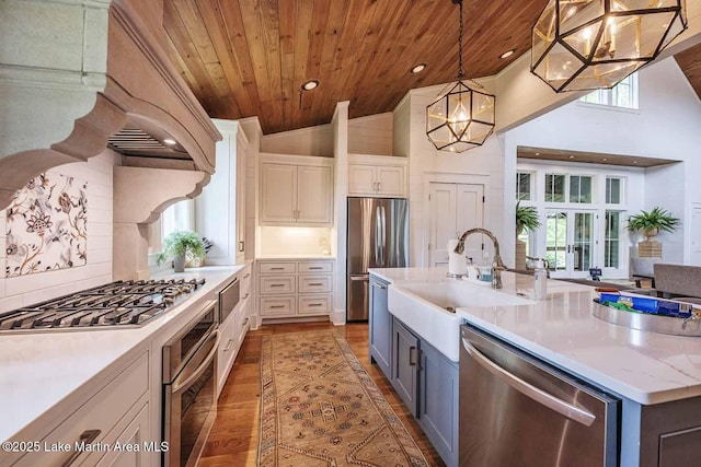 326 Bulgers Mill Loop, Alexander City, AL 35010 - kitchen with appliances with stainless steel finishes, a sink, wood ceiling, backsplash, and wood finished floors