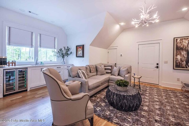 326 Bulgers Mill Loop, Alexander City, AL 35010 - living area with beverage cooler, lofted ceiling, light wood-style floors, a chandelier, and recessed lighting