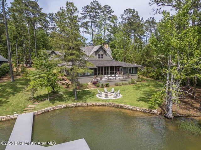 326 Bulgers Mill Loop, Alexander City, AL 35010 - back of property with a fire pit, a yard, a chimney, roof with shingles, and a sunroom