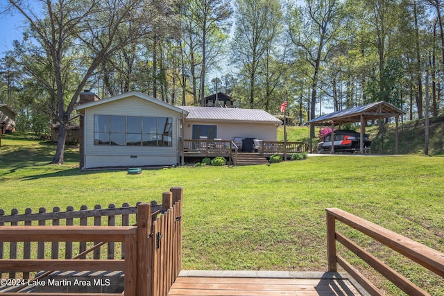 view of yard with a deck and a carport