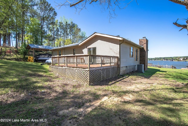 exterior space with central AC, a yard, and a deck with water view