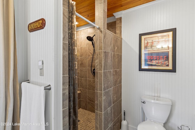 bathroom featuring toilet and a tile shower