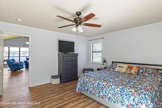 bedroom featuring multiple windows, ceiling fan, and wood-type flooring