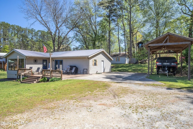 exterior space featuring a carport, a deck, and a front yard