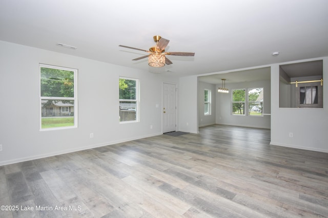 1706 Simpson St, Alexander City, AL 35010 - spare room with wood finished floors, ceiling fan, and a chandelier