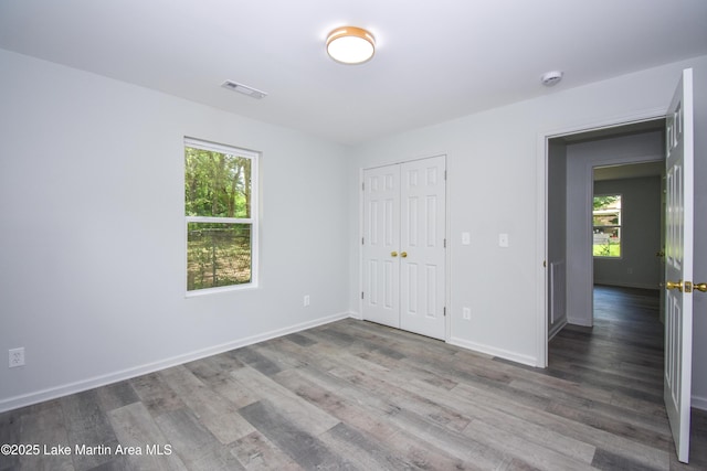 1706 Simpson St, Alexander City, AL 35010 - unfurnished bedroom featuring wood finished floors and a closet