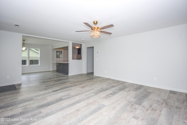 1706 Simpson St, Alexander City, AL 35010 - unfurnished living room featuring wood finished floors and ceiling fan