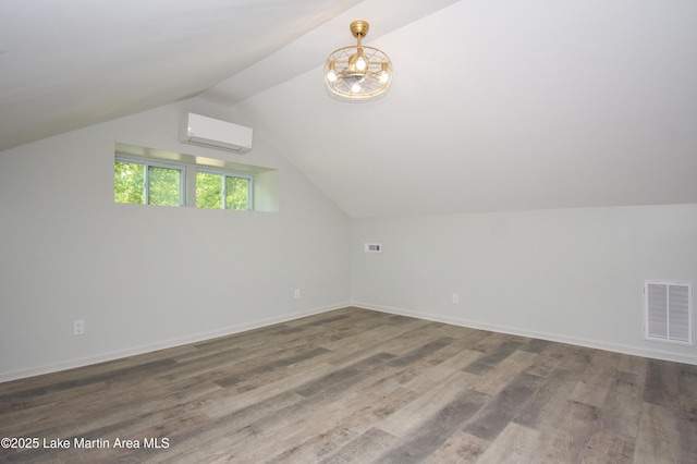 1706 Simpson St, Alexander City, AL 35010 - bonus room featuring a wall mounted air conditioner, wood finished floors, lofted ceiling, and a chandelier