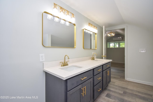 1706 Simpson St, Alexander City, AL 35010 - bathroom with double vanity, wood finished floors, and vaulted ceiling