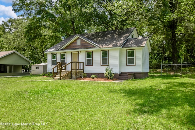 1706 Simpson St, Alexander City, AL 35010 - view of front of home with a metal roof and view of wooded area