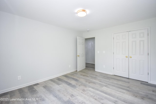 1706 Simpson St, Alexander City, AL 35010 - unfurnished bedroom featuring wood finished floors and a closet