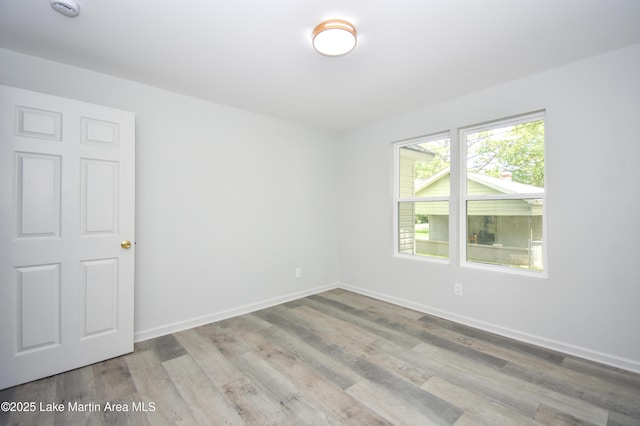 1706 Simpson St, Alexander City, AL 35010 - empty room featuring wood finished floors and a smoke detector