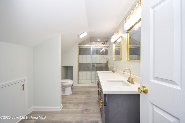 1706 Simpson St, Alexander City, AL 35010 - full bath featuring double vanity, wood finished floors, vaulted ceiling, and a stall shower