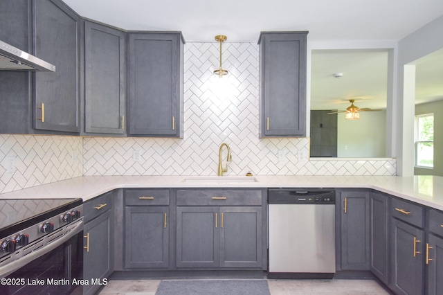 1706 Simpson St, Alexander City, AL 35010 - kitchen featuring appliances with stainless steel finishes, range hood, tasteful backsplash, and light countertops