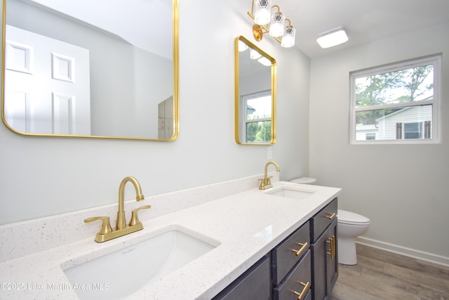 1706 Simpson St, Alexander City, AL 35010 - full bathroom featuring double vanity and wood finished floors