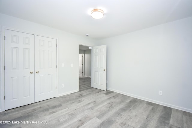 1706 Simpson St, Alexander City, AL 35010 - unfurnished bedroom featuring a closet and wood finished floors