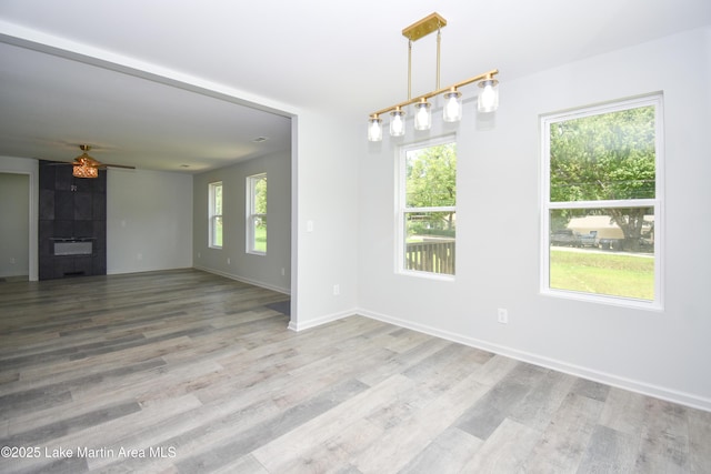 1706 Simpson St, Alexander City, AL 35010 - unfurnished room with a ceiling fan, wood finished floors, and a fireplace