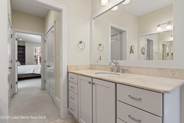 ensuite bathroom with connected bathroom and vanity