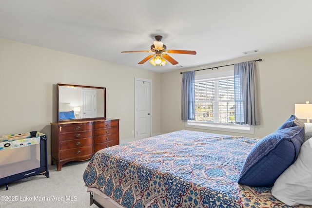 carpeted bedroom with visible vents and a ceiling fan