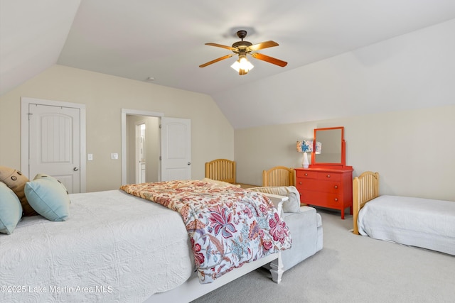 carpeted bedroom with ceiling fan and vaulted ceiling