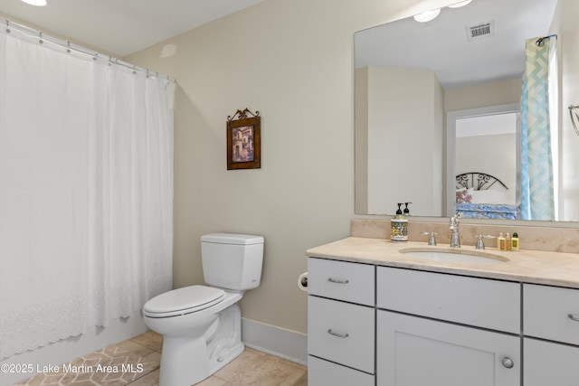 bathroom with visible vents, a shower with shower curtain, toilet, vanity, and tile patterned floors