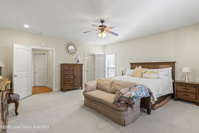 carpeted bedroom with a ceiling fan and recessed lighting