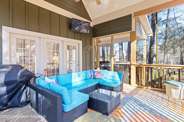 sunroom with a ceiling fan and vaulted ceiling