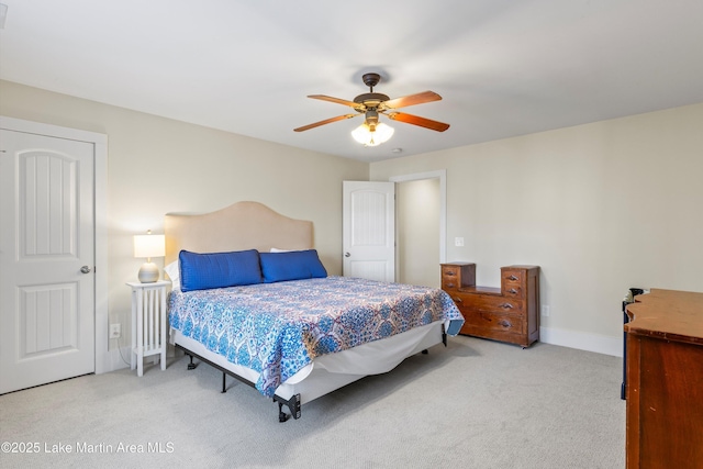 carpeted bedroom with a ceiling fan and baseboards