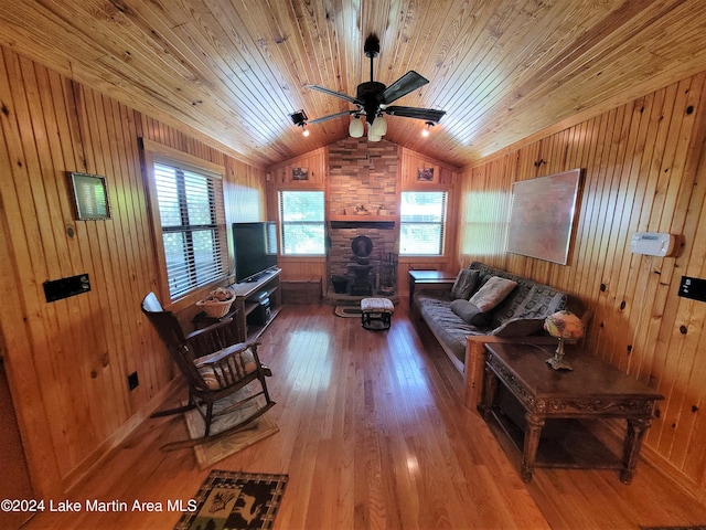 living room featuring wooden walls, ceiling fan, wooden ceiling, and hardwood / wood-style flooring