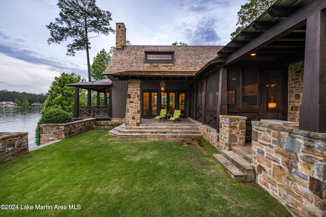 exterior space with a yard and a water view