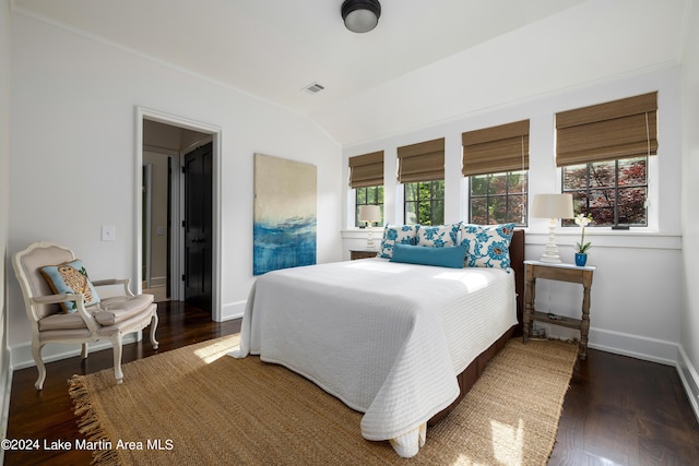 bedroom with lofted ceiling and dark hardwood / wood-style floors