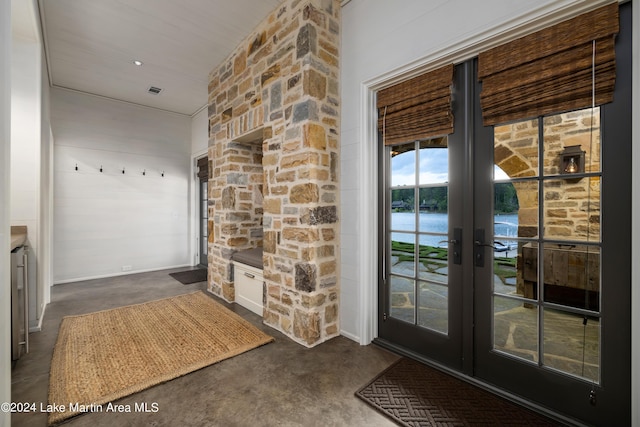 entryway with a water view and french doors