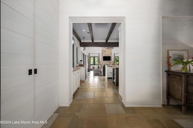 hall featuring beamed ceiling