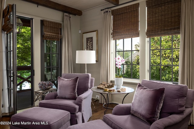 sunroom featuring beam ceiling