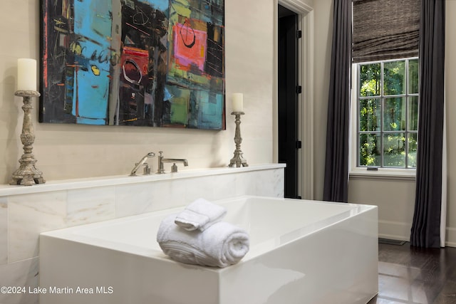 bathroom featuring hardwood / wood-style floors and a washtub