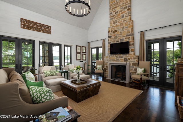 living room featuring a fireplace, french doors, high vaulted ceiling, and a healthy amount of sunlight