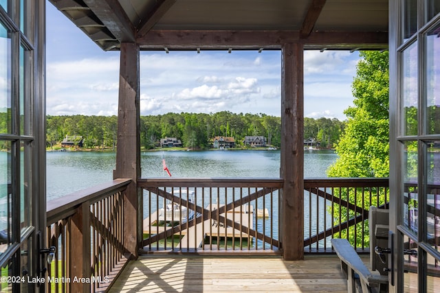 wooden terrace featuring a water view