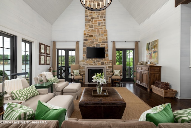 living room featuring a fireplace, french doors, dark hardwood / wood-style flooring, and high vaulted ceiling