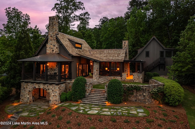 back house at dusk with a patio area