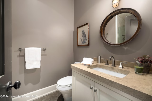 bathroom featuring vanity and toilet